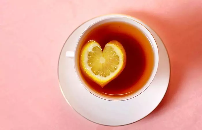 Heart shaped lemon slice in lemon tea to emphasize improved heart health from Vitamin C in it