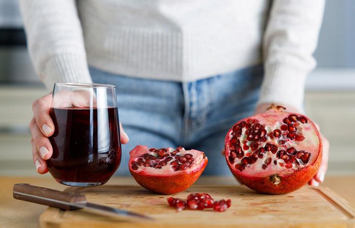 Woman ready to use pomegranate for rejuvinating the skin