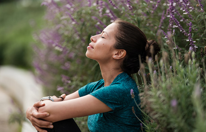 Woman meditating to improve skin elasticity