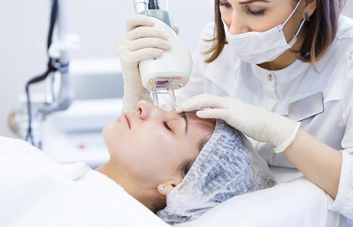 Woman undergoing laser therapy to reduce nose pores