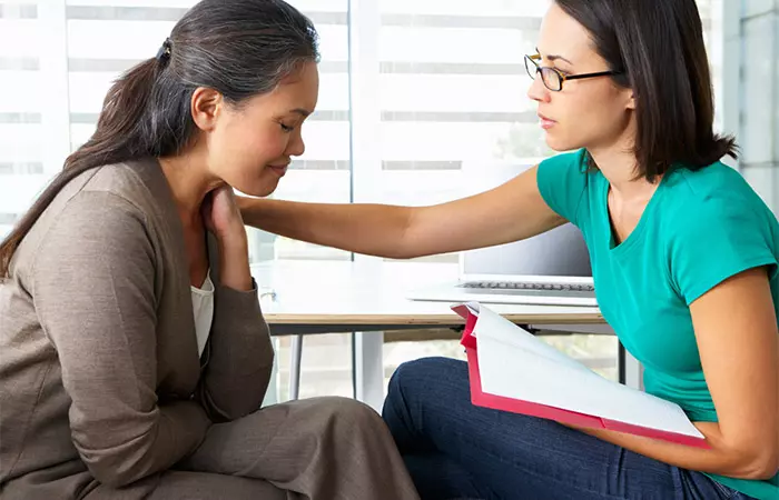 Counsellor consoling crying woman