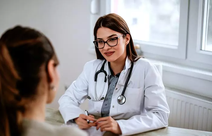 A woman talking with her doctor before using calamine lotion