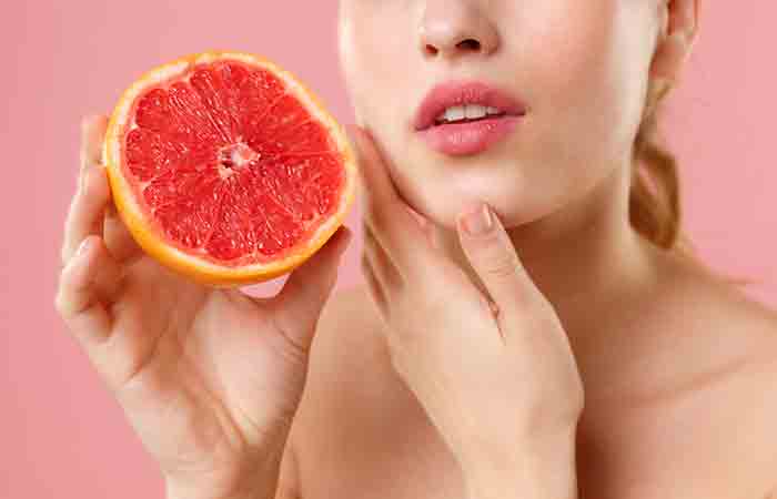 Woman with flawless skin holding a grapefruit