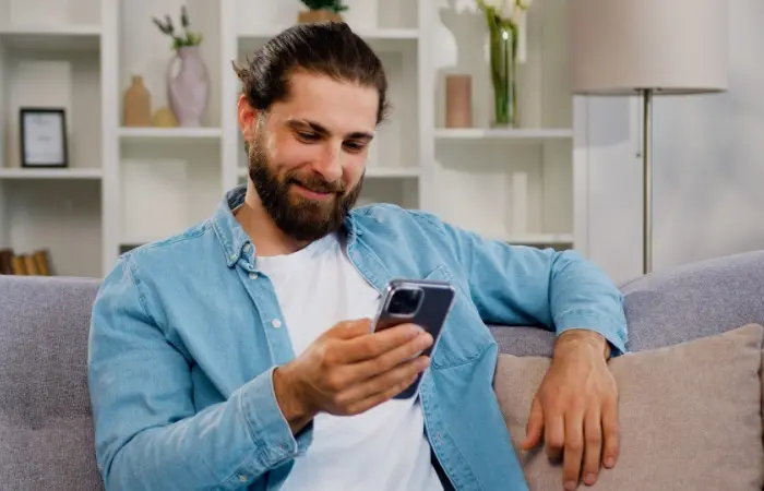 A man typing a long love message on his mobile phone