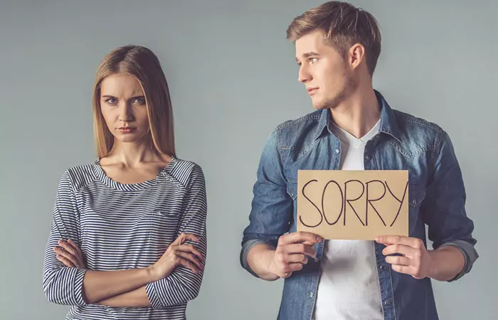 Man apologizing to woman