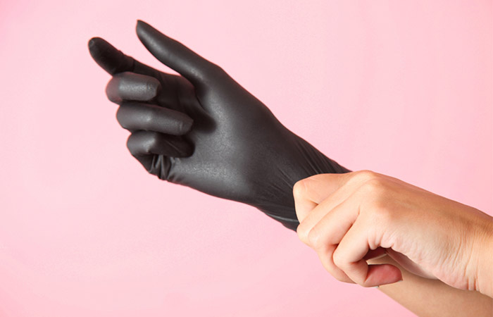 Person wearing latex gloves before applying monistat
