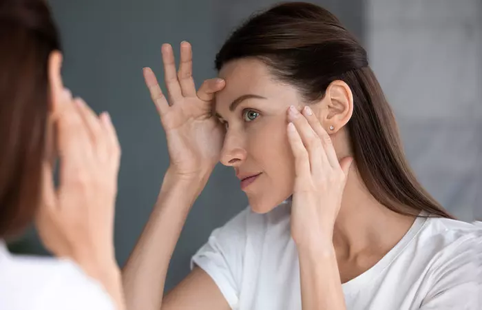 Woman looking at healthy skin after consuming copper