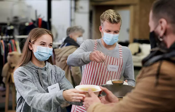 Couple serving food at a local charity