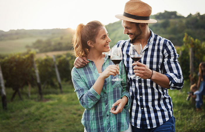 Couple in a vineyard having wine together