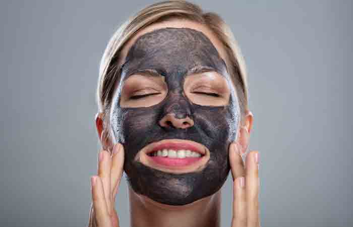 Mujer con máscara facial de carbón activado