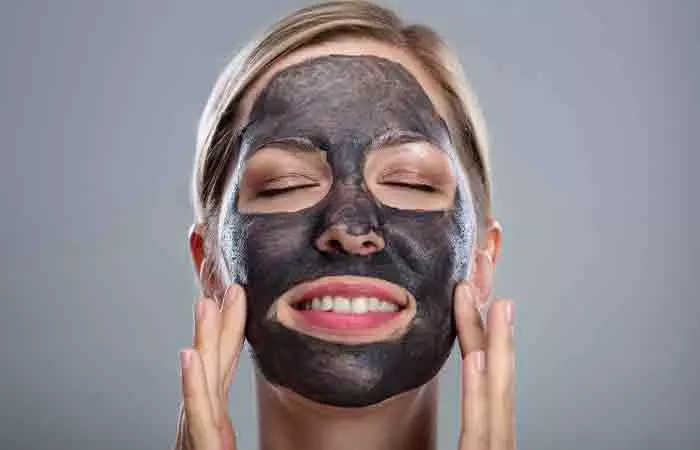 Woman with activated charcoal face mask