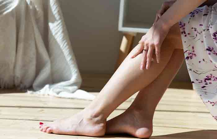 Woman flaunting moisturized healthy feet ater using foot soaks.