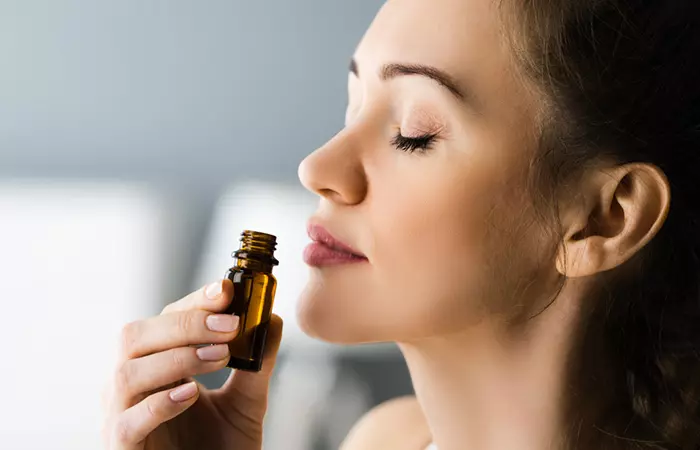 Woman inhaling camphor oil to soothe itchy skin