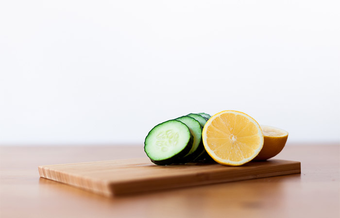 Cucumber and lemon on a wooden board