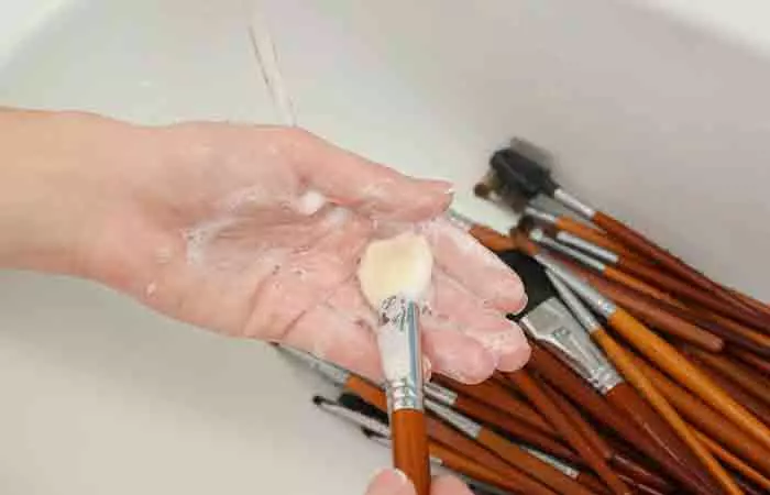 Woman cleaning makeup brushes for oily skin