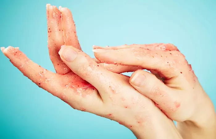 Woman using an exfoliating shower gel