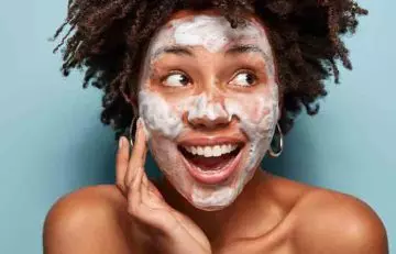 Woman with soap foam on face