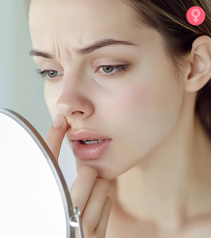 Girl applying ointment on her face