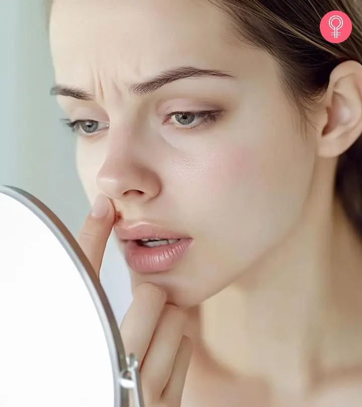 Girl applying ointment on her face