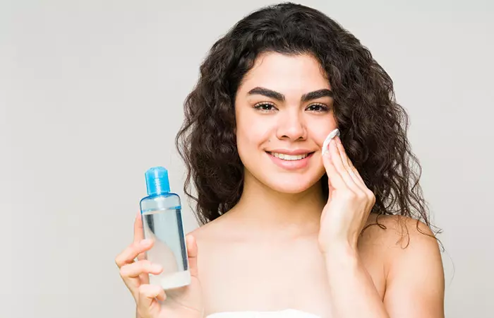 Woman removing makeup with baby oil