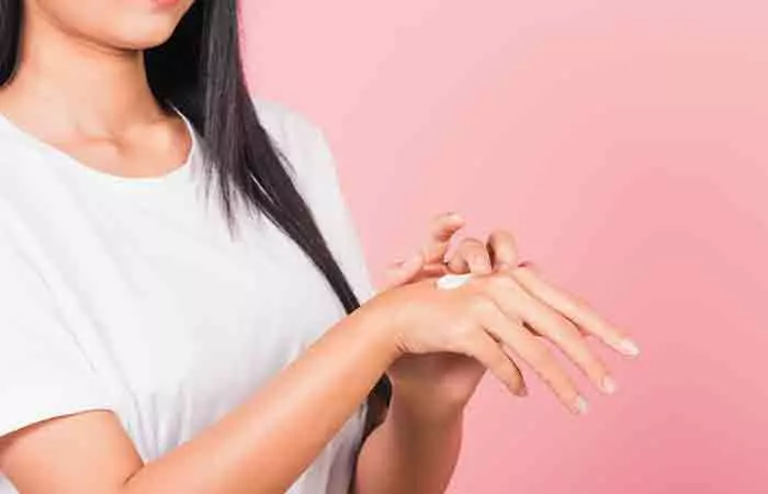 Woman does a patch test before using sodium PCA product. 