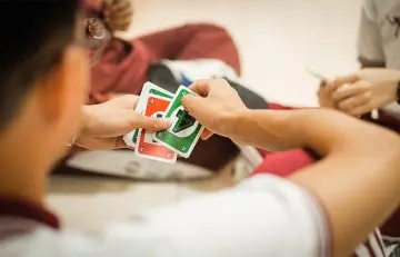 Close up of family playing UNO