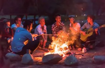 A group of family gathered around a campfire
