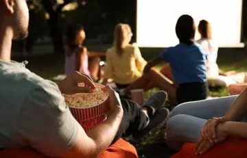 A family watching a movie outside