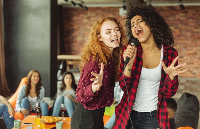 A group of family singing and enjoying the karaoke night