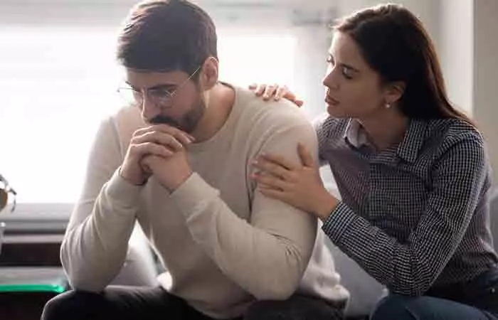 Couple resolving issue calmly on couch