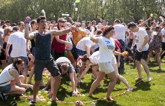 Water balloon fight at a big family reunion