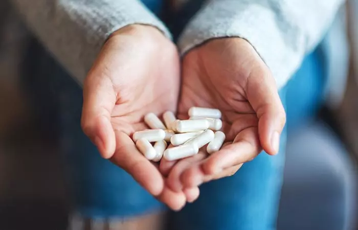 Woman holding MSM capsules