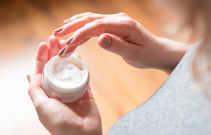Woman uses MSM cream for healthy skin.