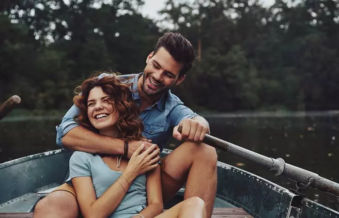 A beautiful couple rowing together in a serene lake