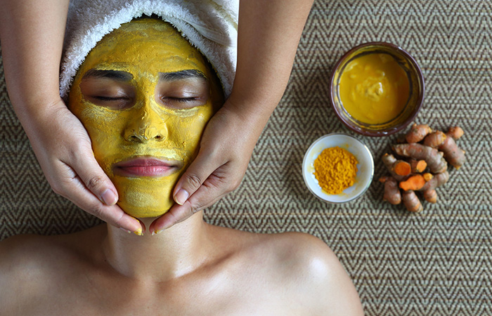 A woman with turmeric face mask.