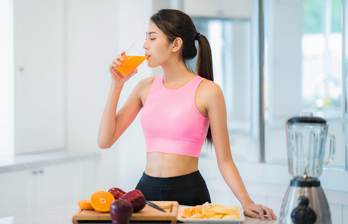 Woman drinking fruit juice for clear liquid diet.