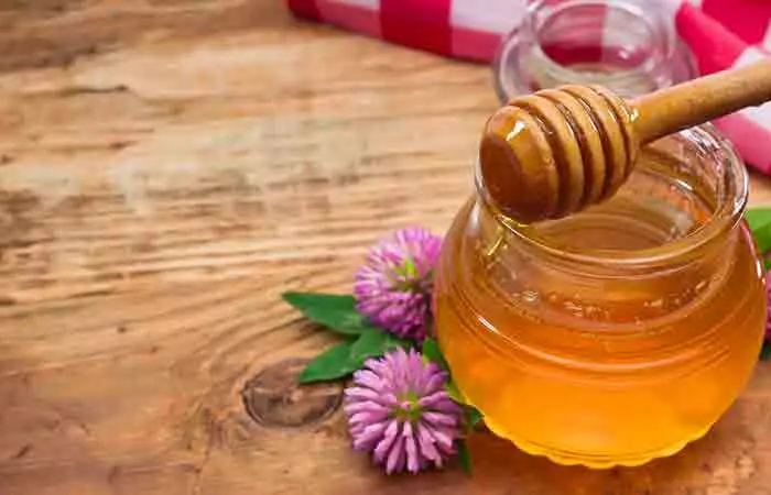 Clover flowers and honey on a table