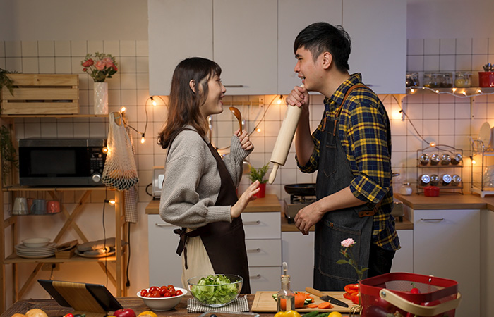 Couple having fun while cooking together