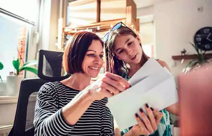 A woman reading a loving letter from her daughter