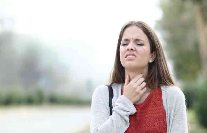 Woman experiencing throat irritation due to the side effects of balsamic vinegar