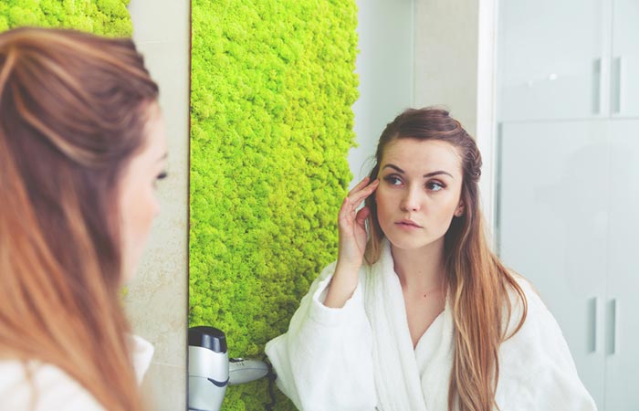 Woman checking her faded wrinkles after using argireline 