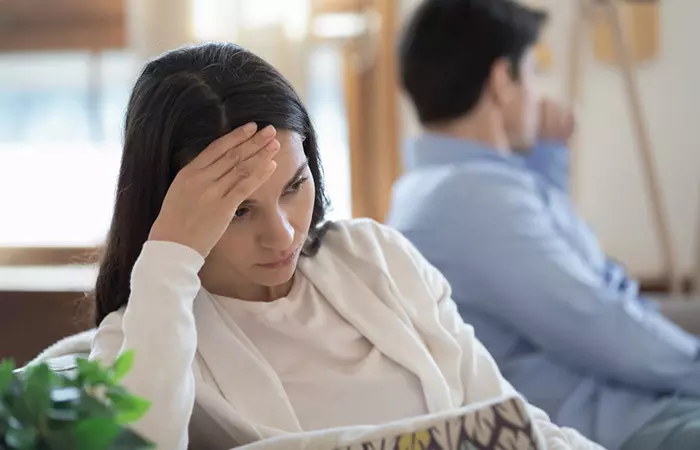 A disappointed woman sitting after fighting with her partner.