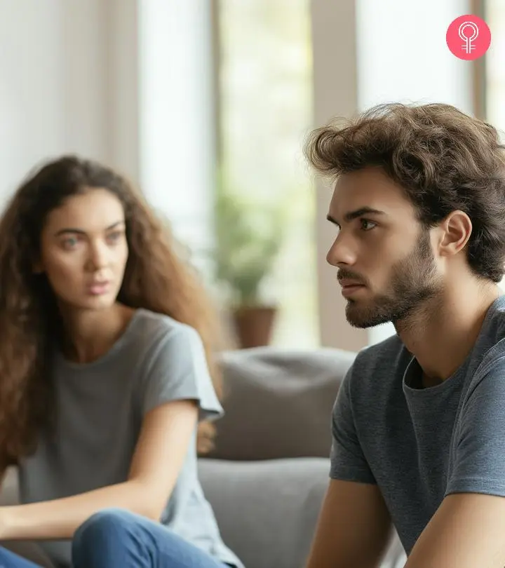 Couple sitting on a sofa and drinking coffee