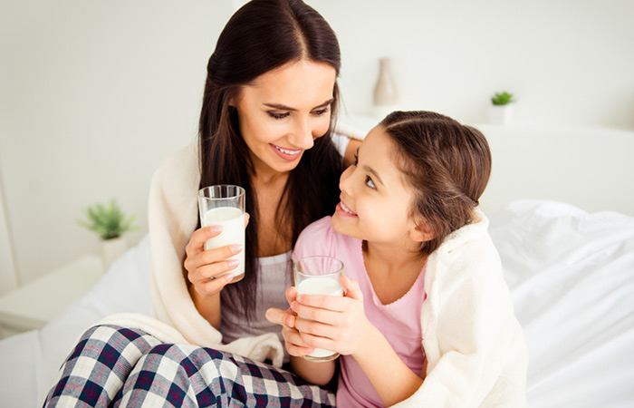 Mother and daughter drinking buttermilk at night