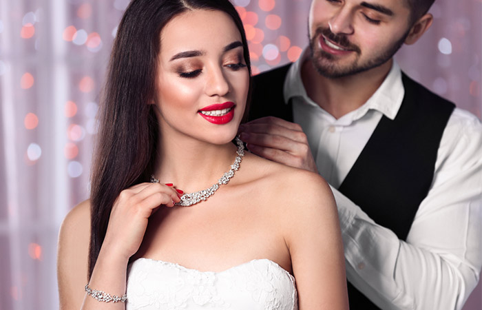 Virgo man in love putting jewelery on his woman
