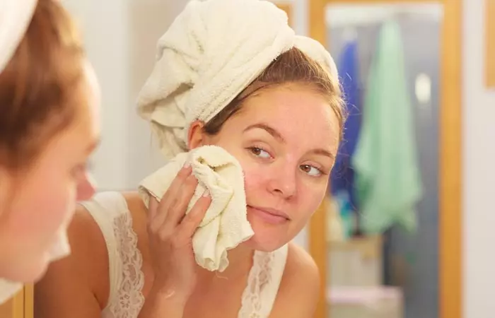 Woman applying cold compress on inflamed skin