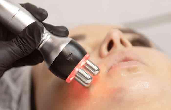 Professional performing Forma skin treatment on a woman's face
