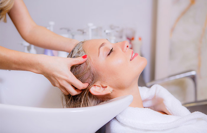 Salon professional uses olaplex for hair bond maintenance.