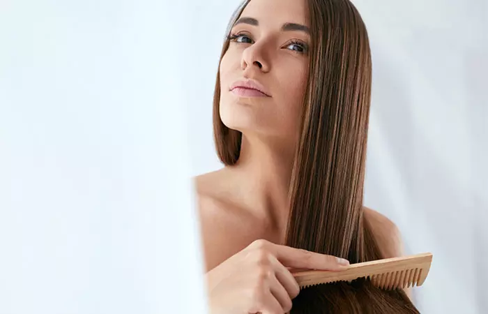 A woman combing her straight hair