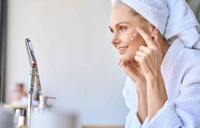 Woman applies moisturizer on her skin before Forma treatment